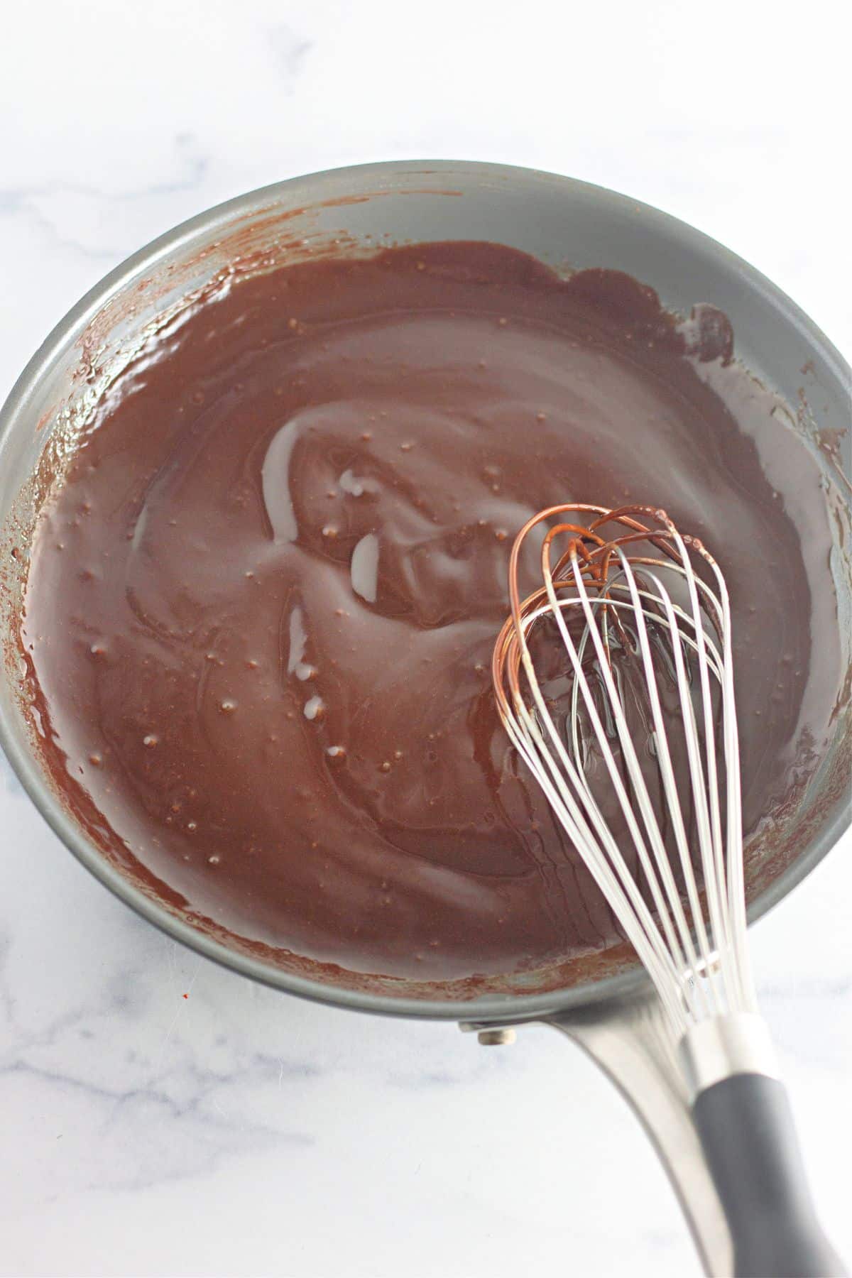 chocolate ganache being made in a skillet.