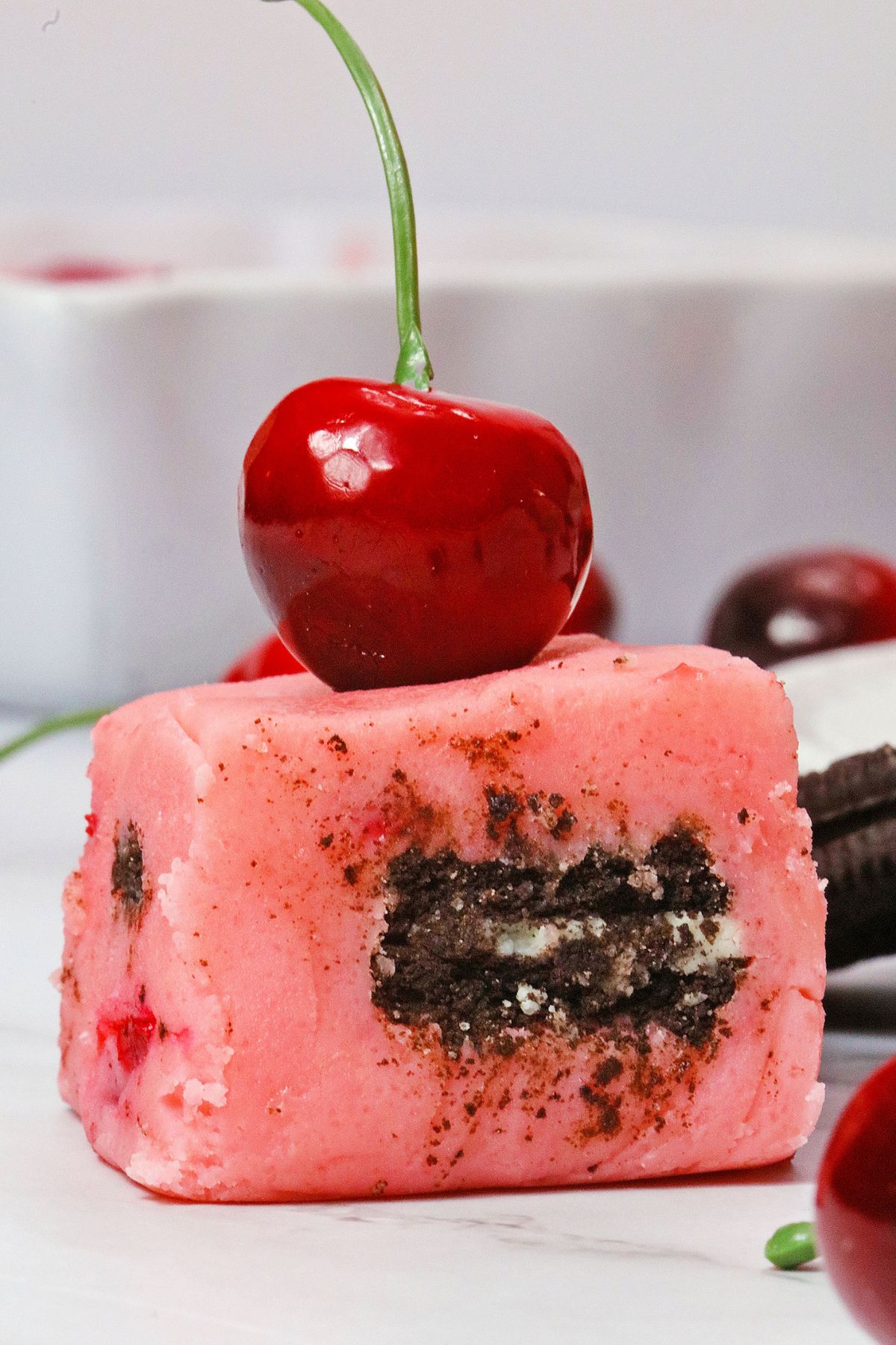 slice of chocolate cherry fudge topped with a cherry.