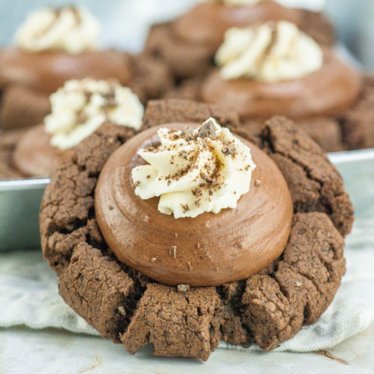 chocolate silk cookies on a kitchen towel.