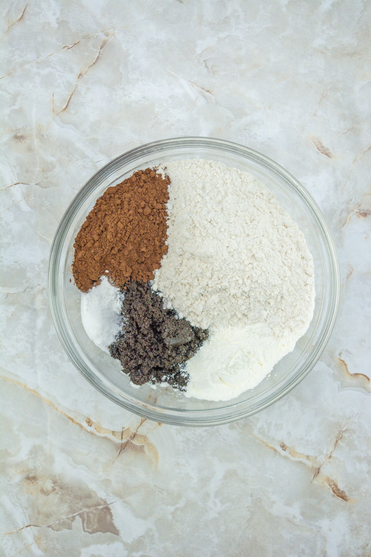 flour, cocoa powder, salt, baking soda, and baking powder in a mixing bowl.