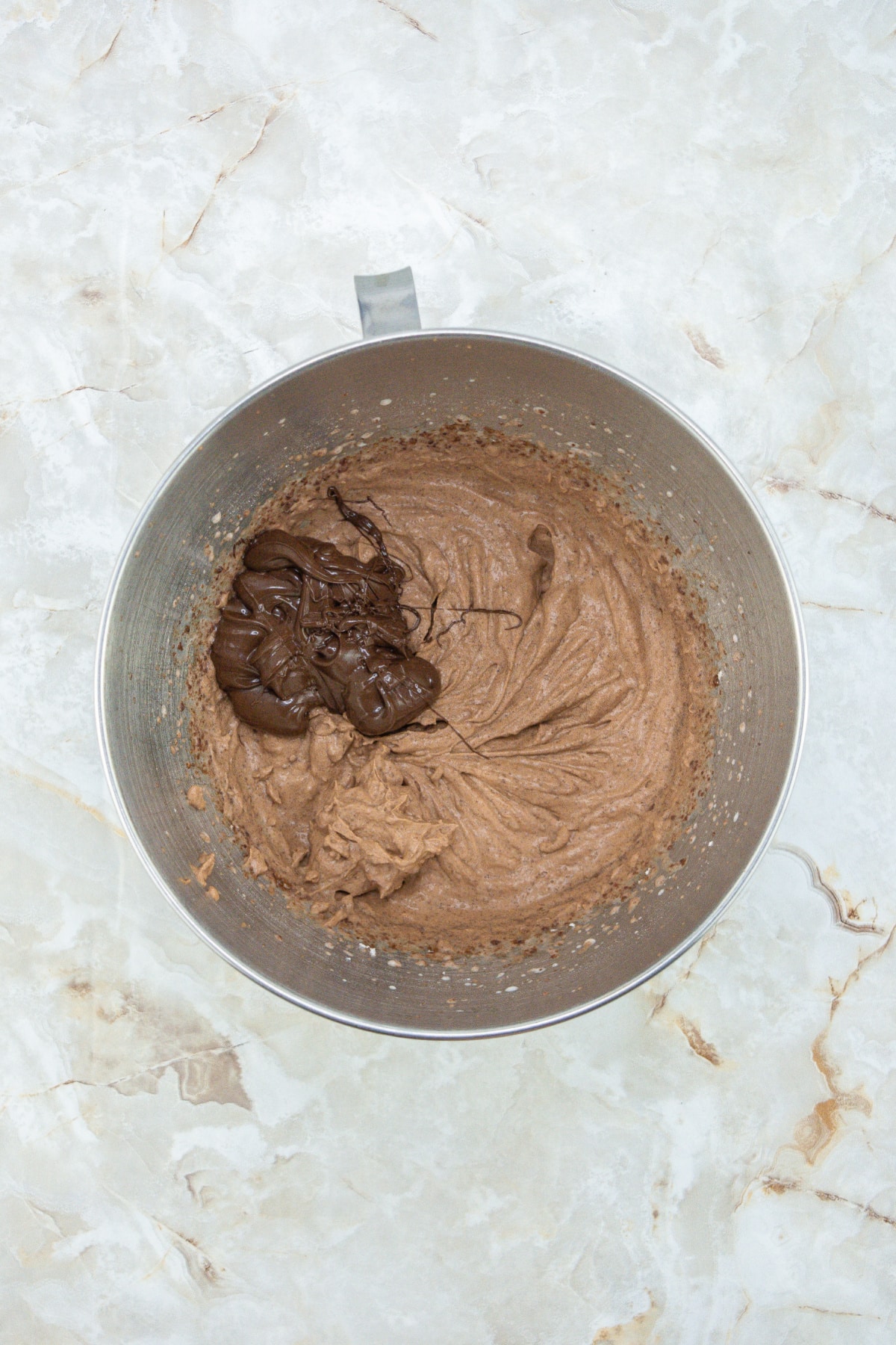 chocolate filling being made in a stand mixer.