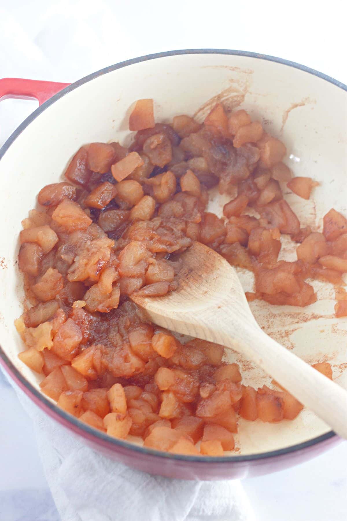 cooked apples in a saucepan.