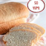 country white bread loaf with three slices cut.