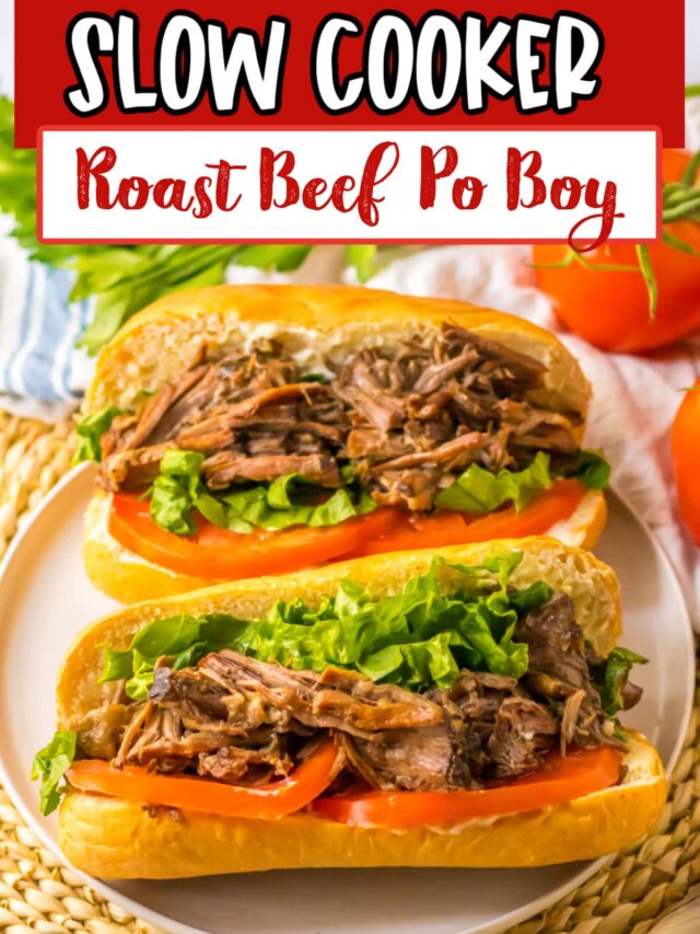 two slow cooker beef po boy sandwiches on a plate.