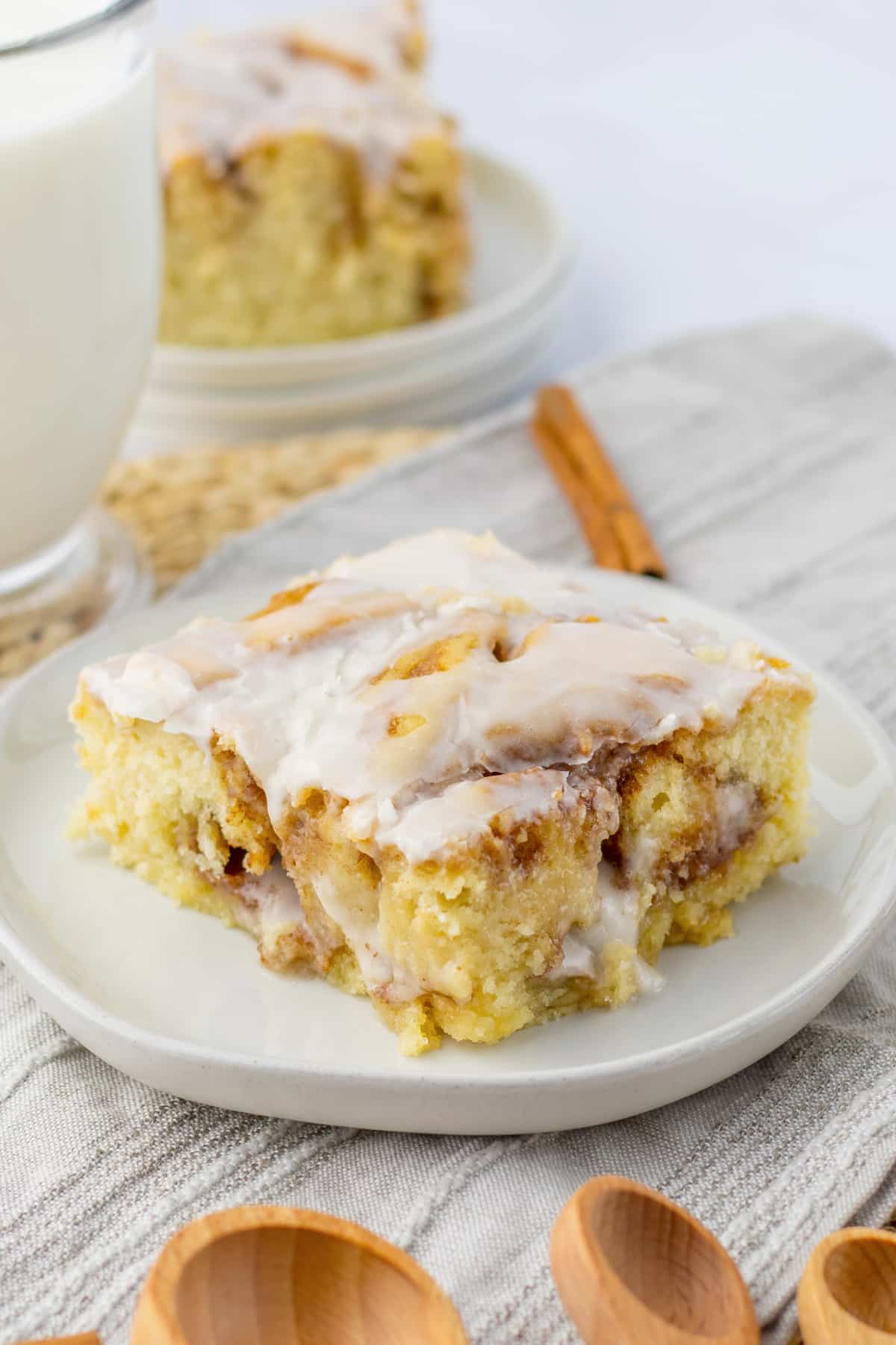 slice of ooey gooey cinnamon roll cake on a small plate.