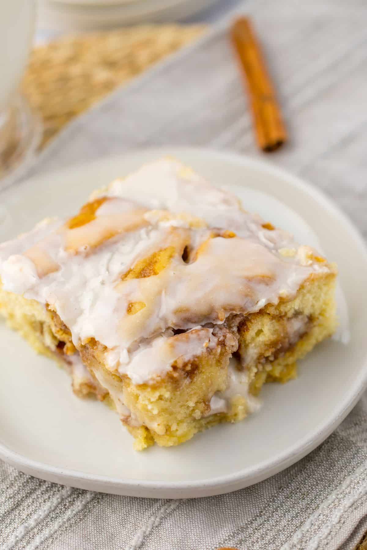 slice of ooey gooey cinnamon roll cake on a small plate.