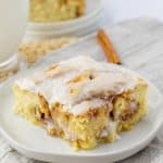 slice of ooey gooey cinnamon roll cake on a small plate.