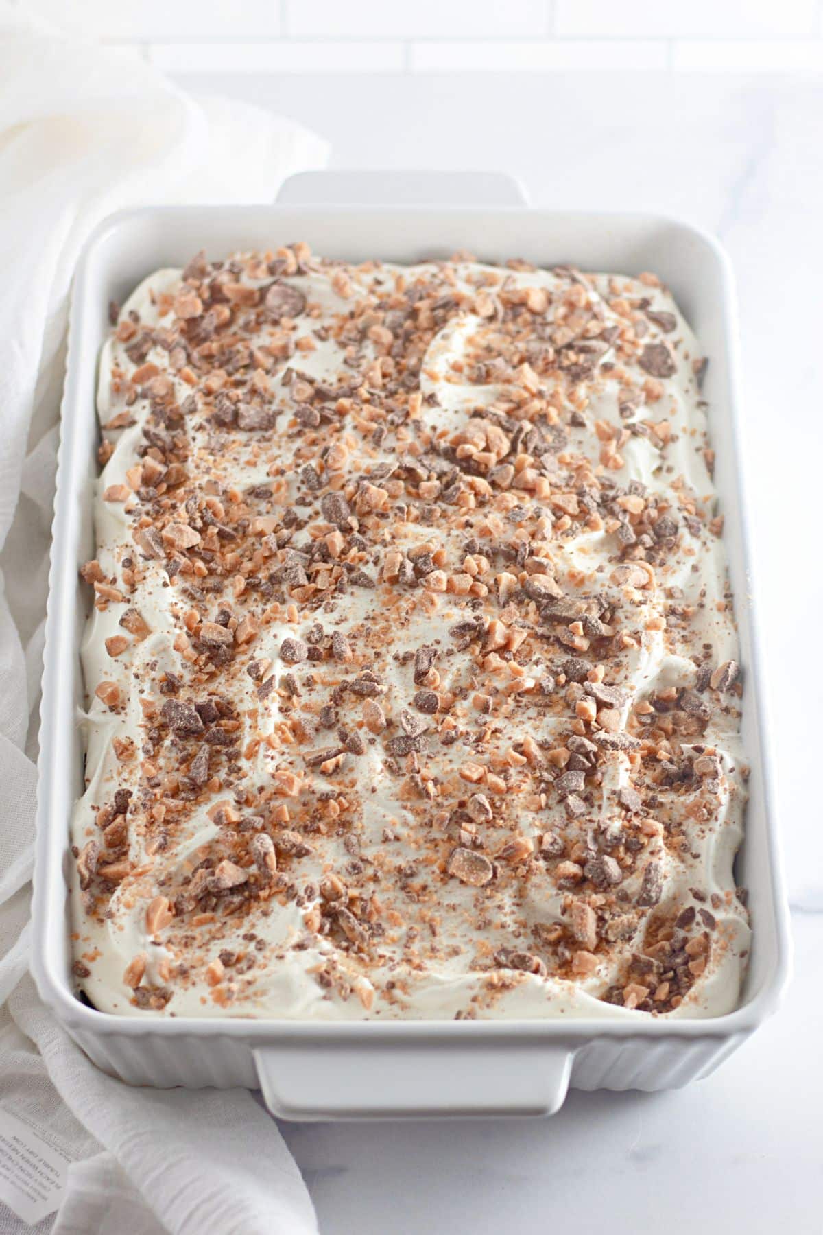 uncut poke cake in a casserole dish.