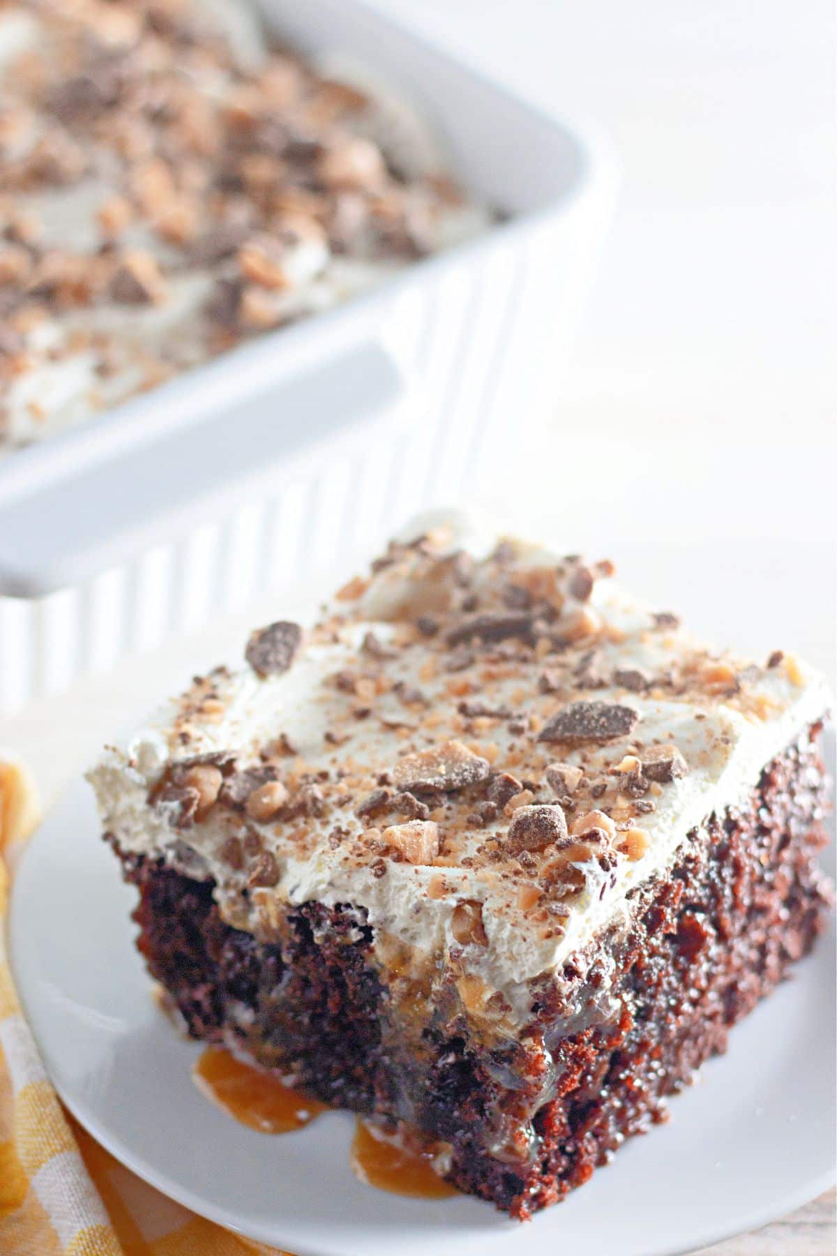 slice of health bar poke cake on a small plate.