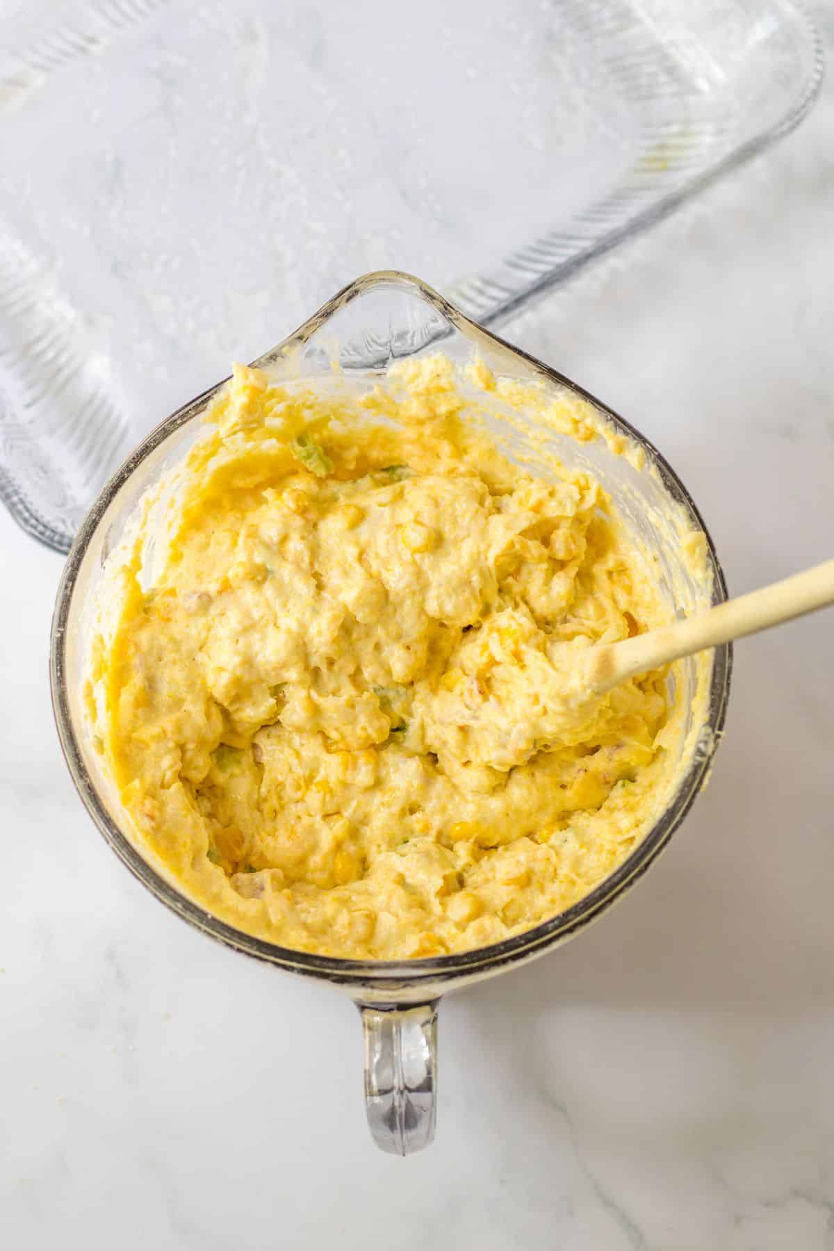 cornbread mixture in a glass mixing bowl.