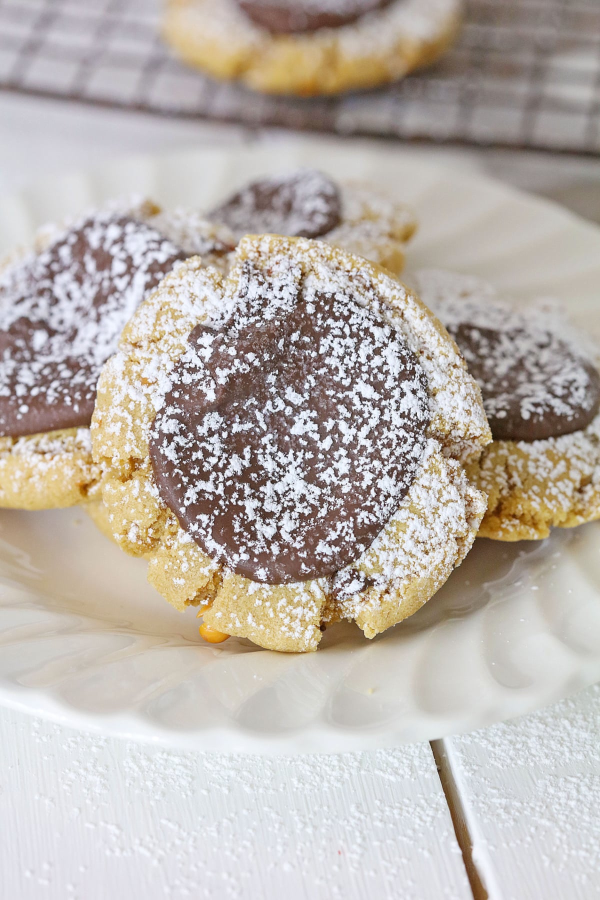 four muddy buddy cookies on a plate.