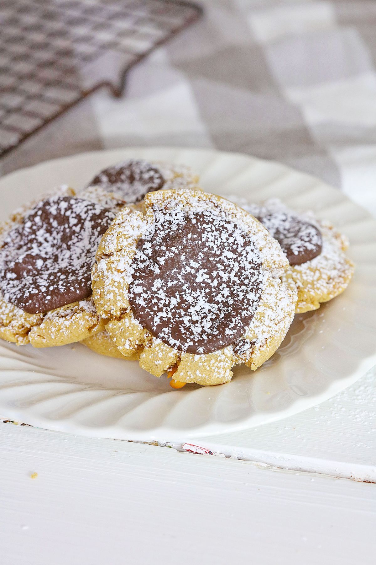 four muddy buddy cookies on a plate.