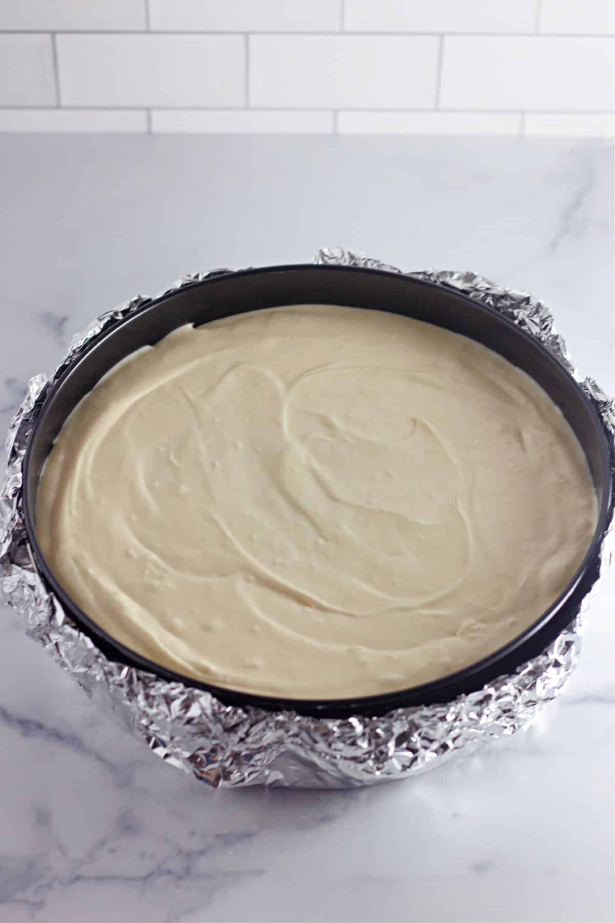 cheesecake in a springform pan ready for the oven.