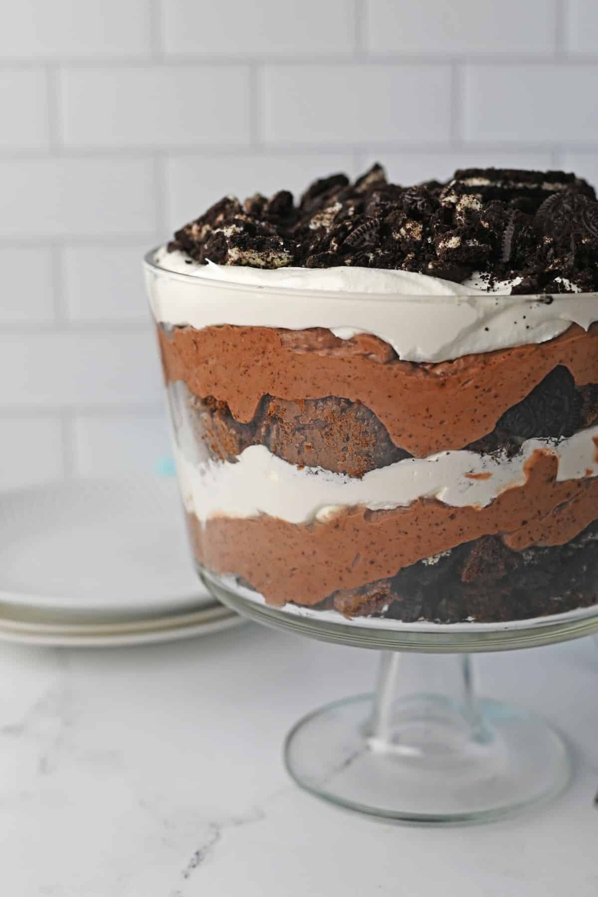 trifle bowl filled with oreo brownie trifle on a counter.