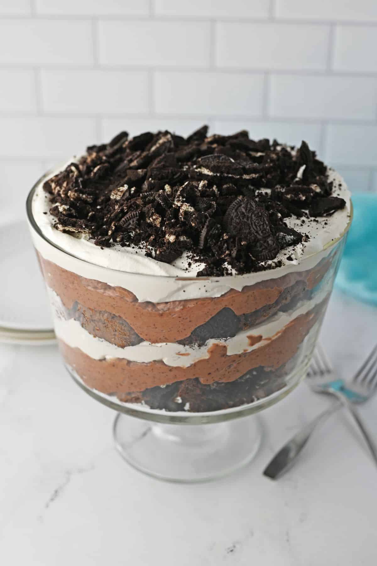 trifle bowl filled with oreo brownie trifle on a counter.