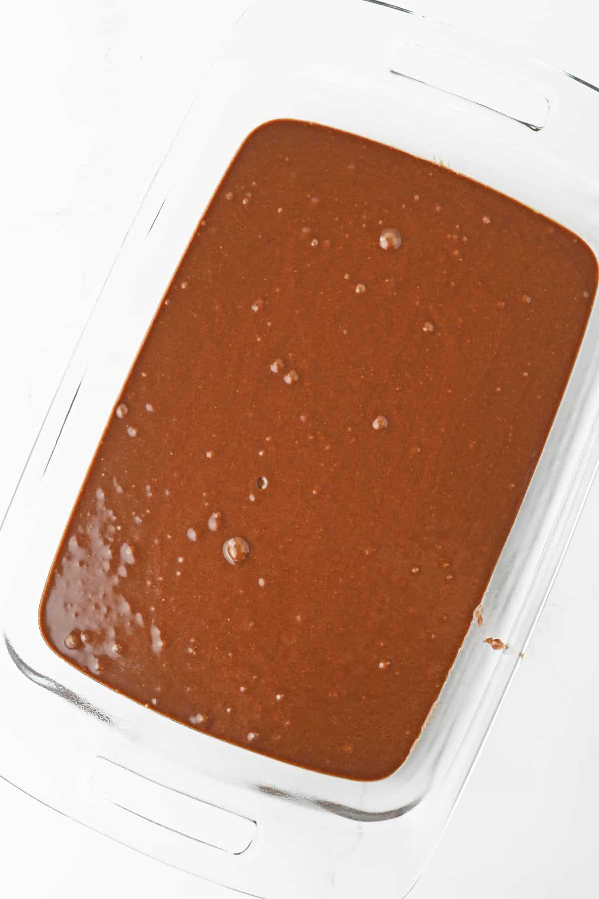 brownie batter in a casserole dish ready for the oven.