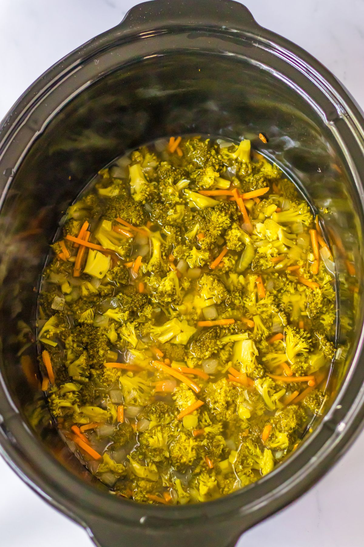 broccoli, carrots, onion and celery cooked in a slow cooker.