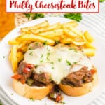 slow cooker philly cheesesteak bites on top of bread slices on a plate.