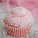 pink champagne cupcake on a marble counter.
