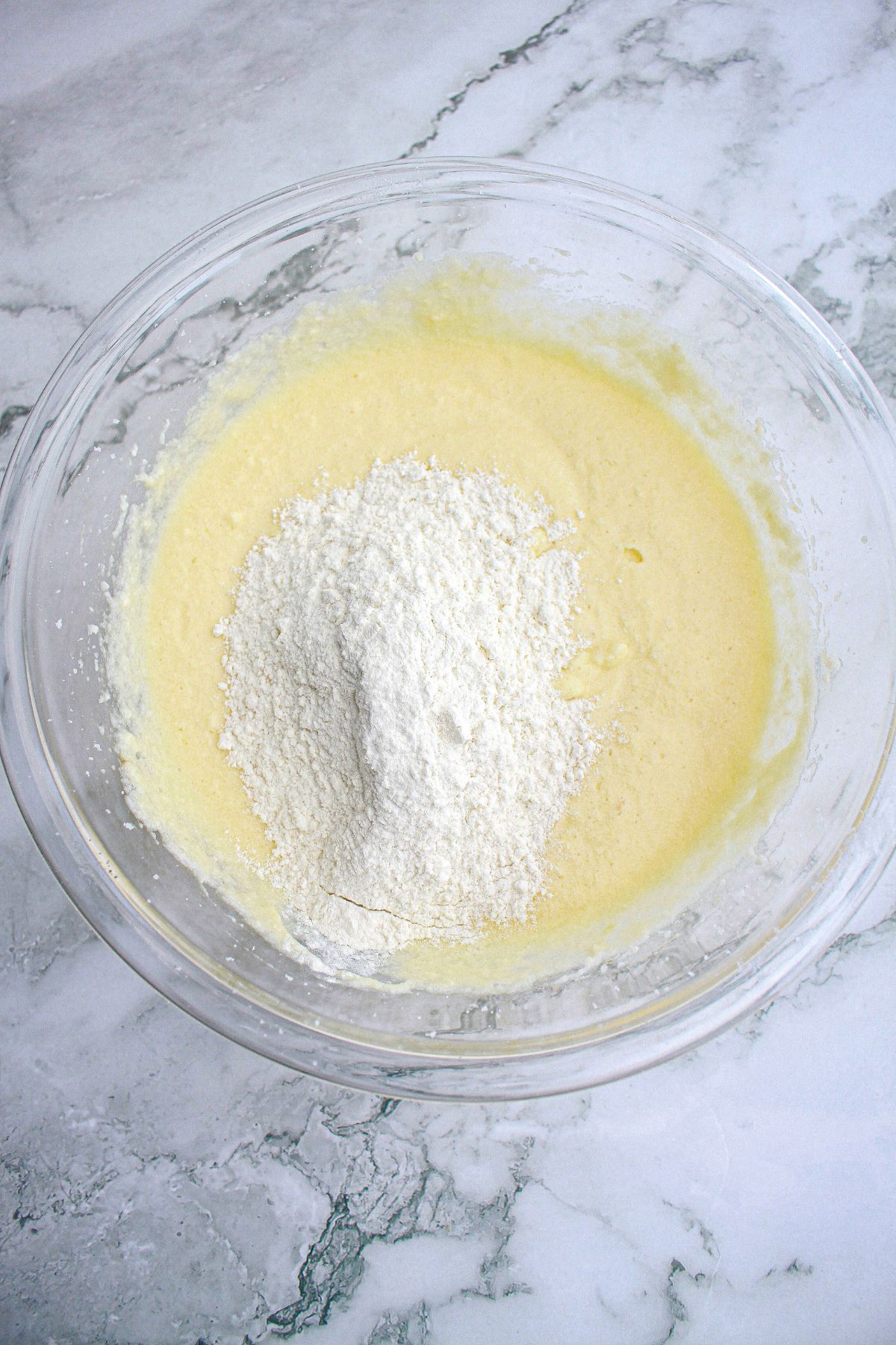 dry ingredients being added to cupcake batter.