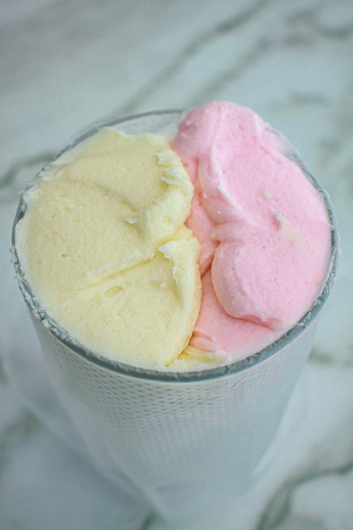 pink and yellow frosting be added to a piping bag.