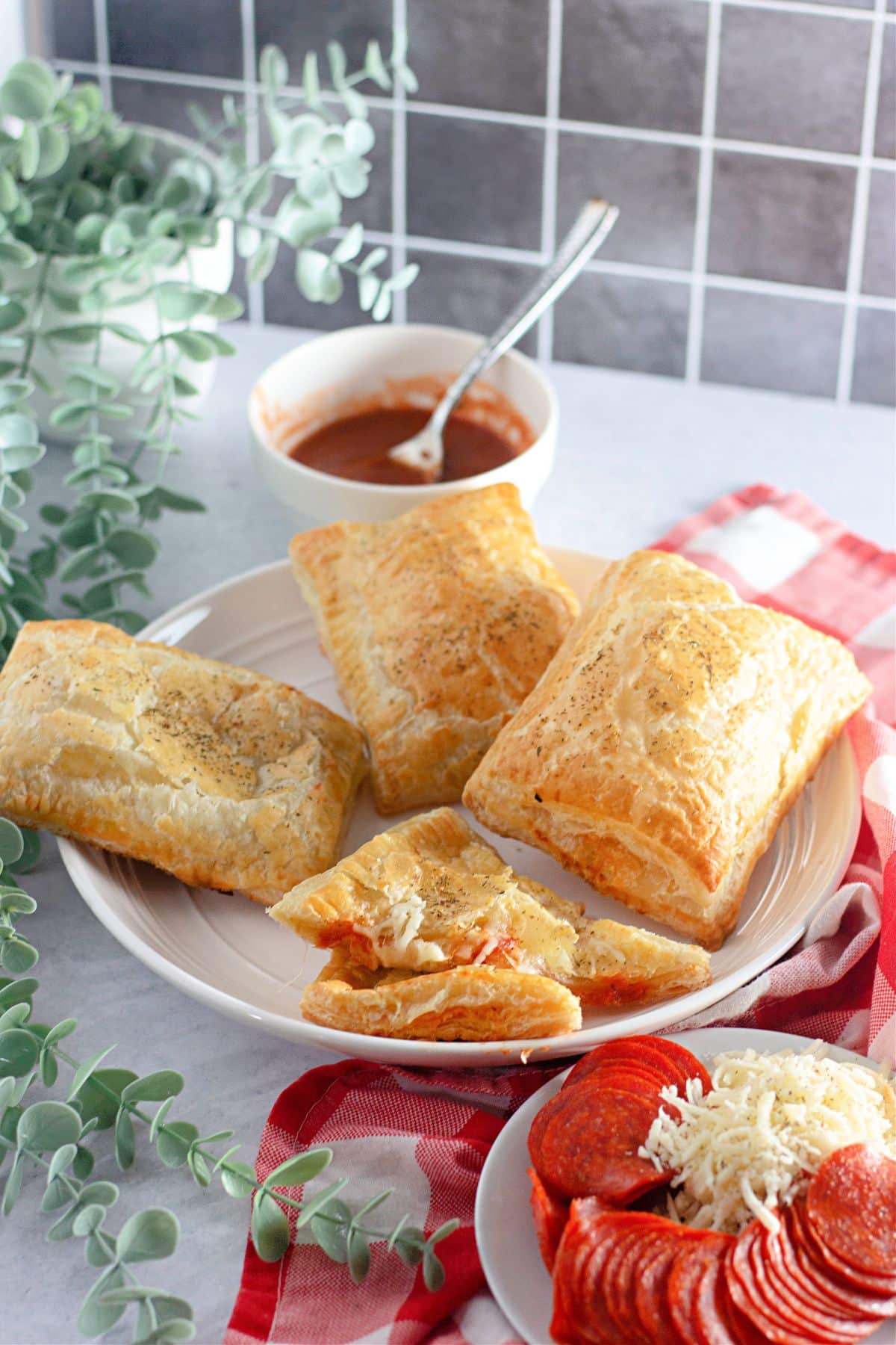 puff pastry pizza pockets on a plate.