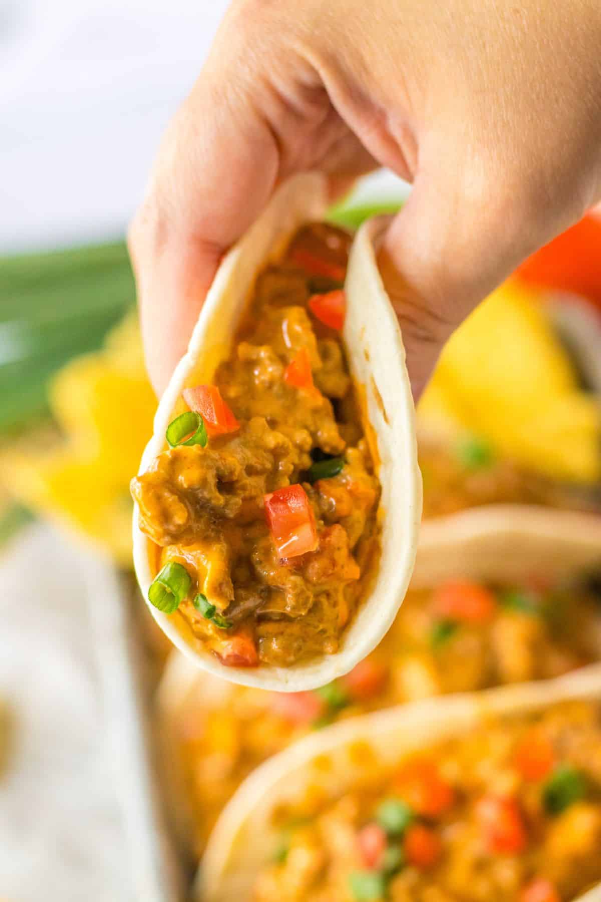 rotel taco held in a woman's hand.