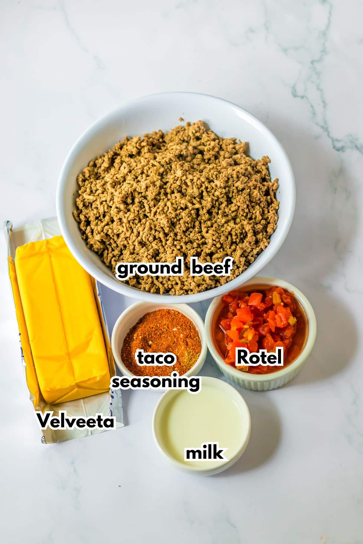 bowls of ground beef, velveeta, taco seasoning, rotel and milk.