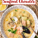 bowl full of seafood chowder on a bamboo place mat.