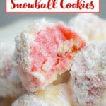 stack of strawberry snowball cookies with the top cookie bitten in half.
