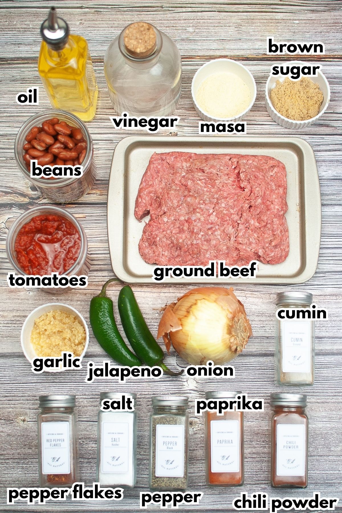 ingredients to make texas roadhouse chili lined up on a backdrop ready to make chili.