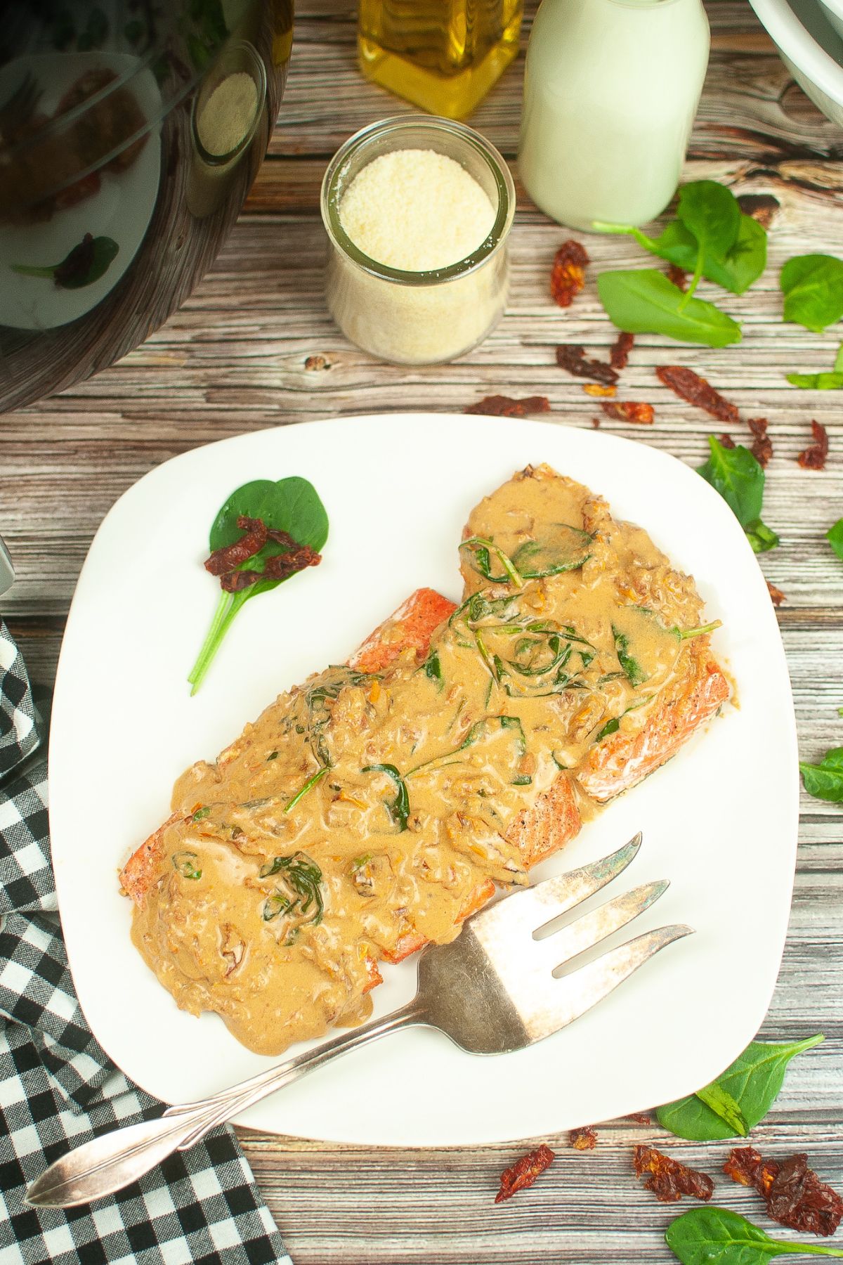 finished tuscan salmon on a white serving platter.