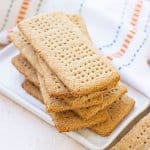 whole wheat graham crackers stacked on a small plate.