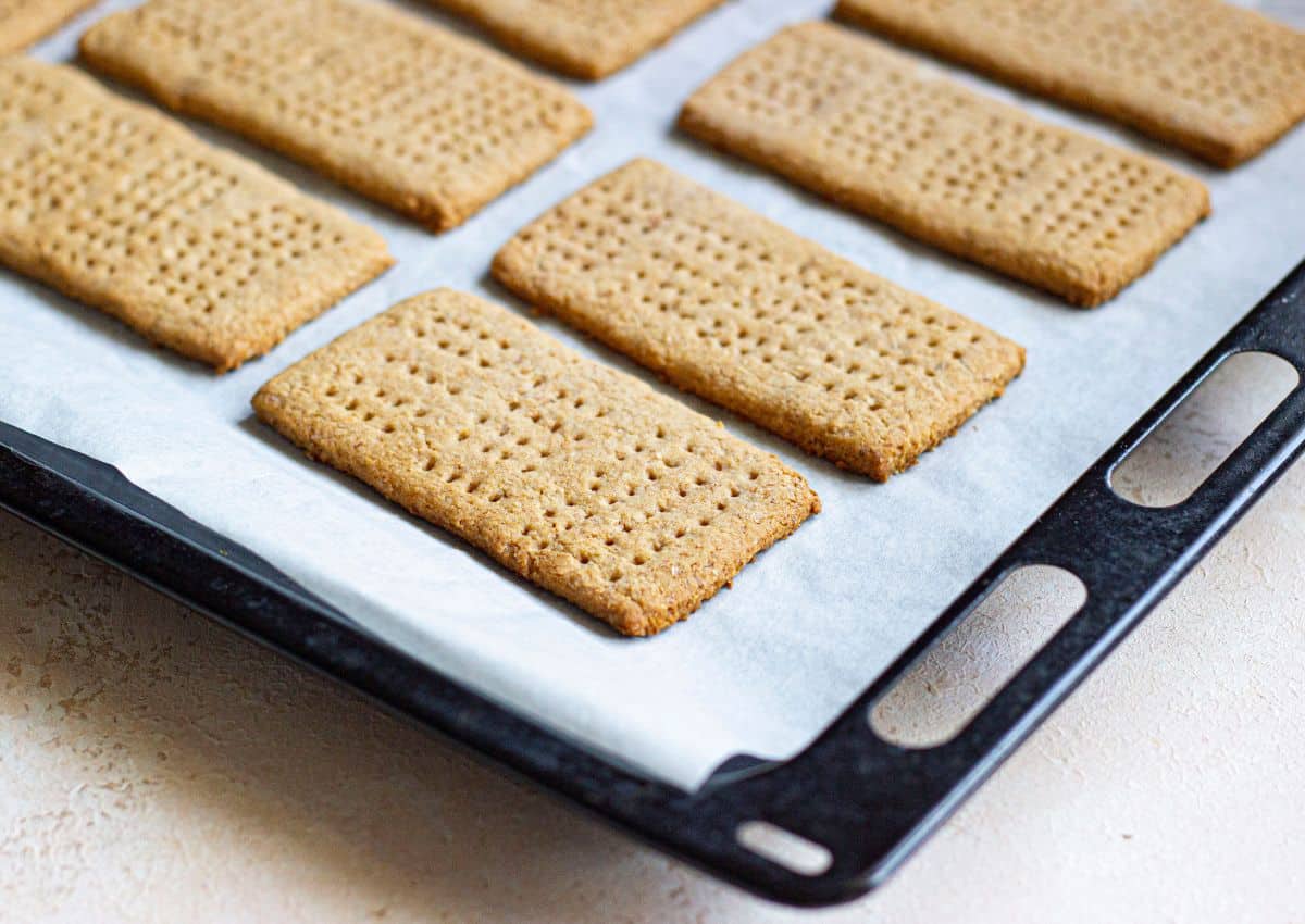 baked whole wheat graham crackers on a parchment lined baking sheet.