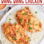 air fryer bang bang chicken on top of a bed of white rice on a plate.