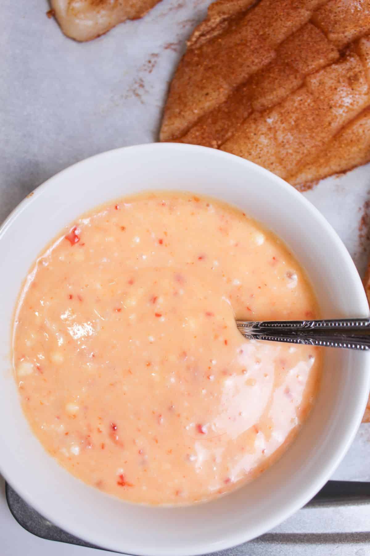 bang bang sauce being mixed in a small bowl.