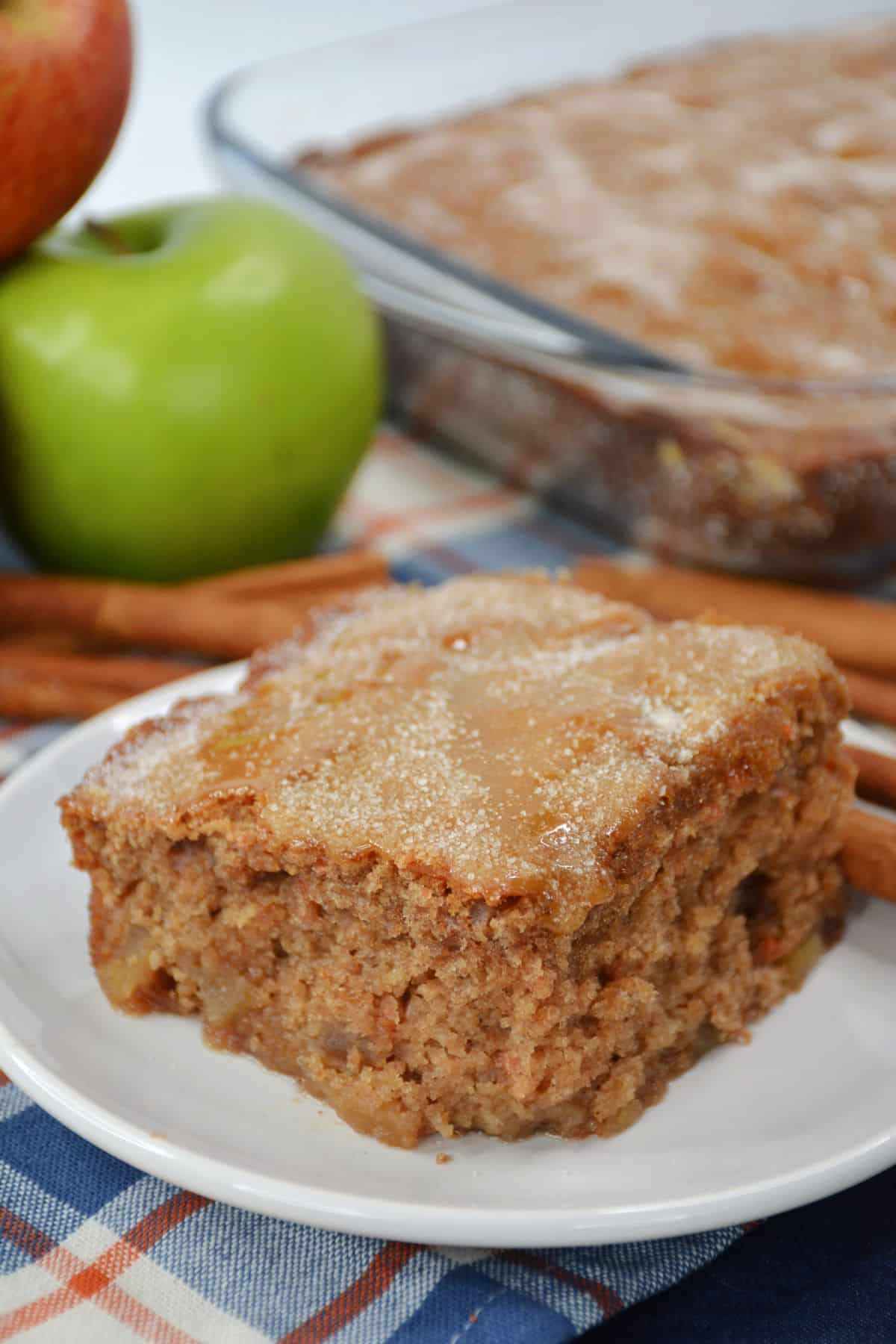 slice of apple cake topped with cinnamon sugar on a plate.