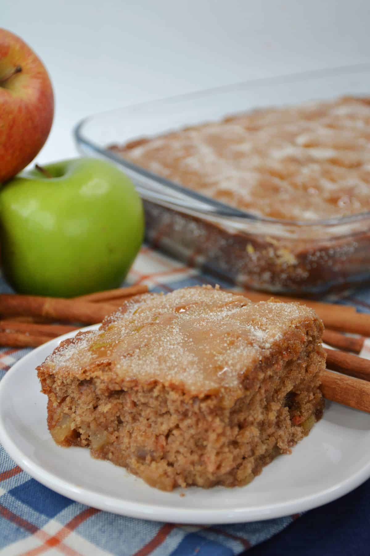 slice of apple cake topped with cinnamon sugar on a plate.
