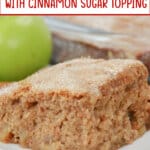 slice of apple cake topped with cinnamon sugar on a plate.