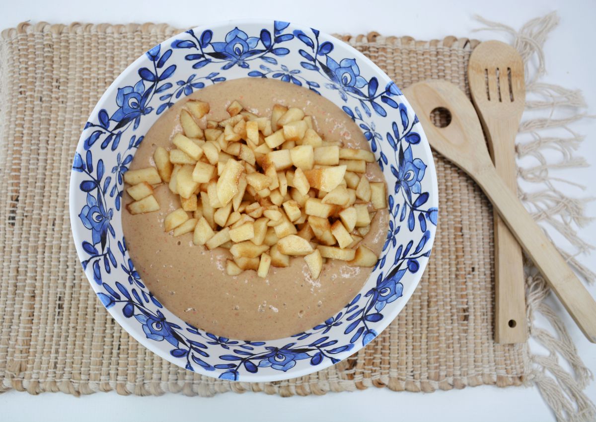apples being added to cake batter in large mixing bowl.
