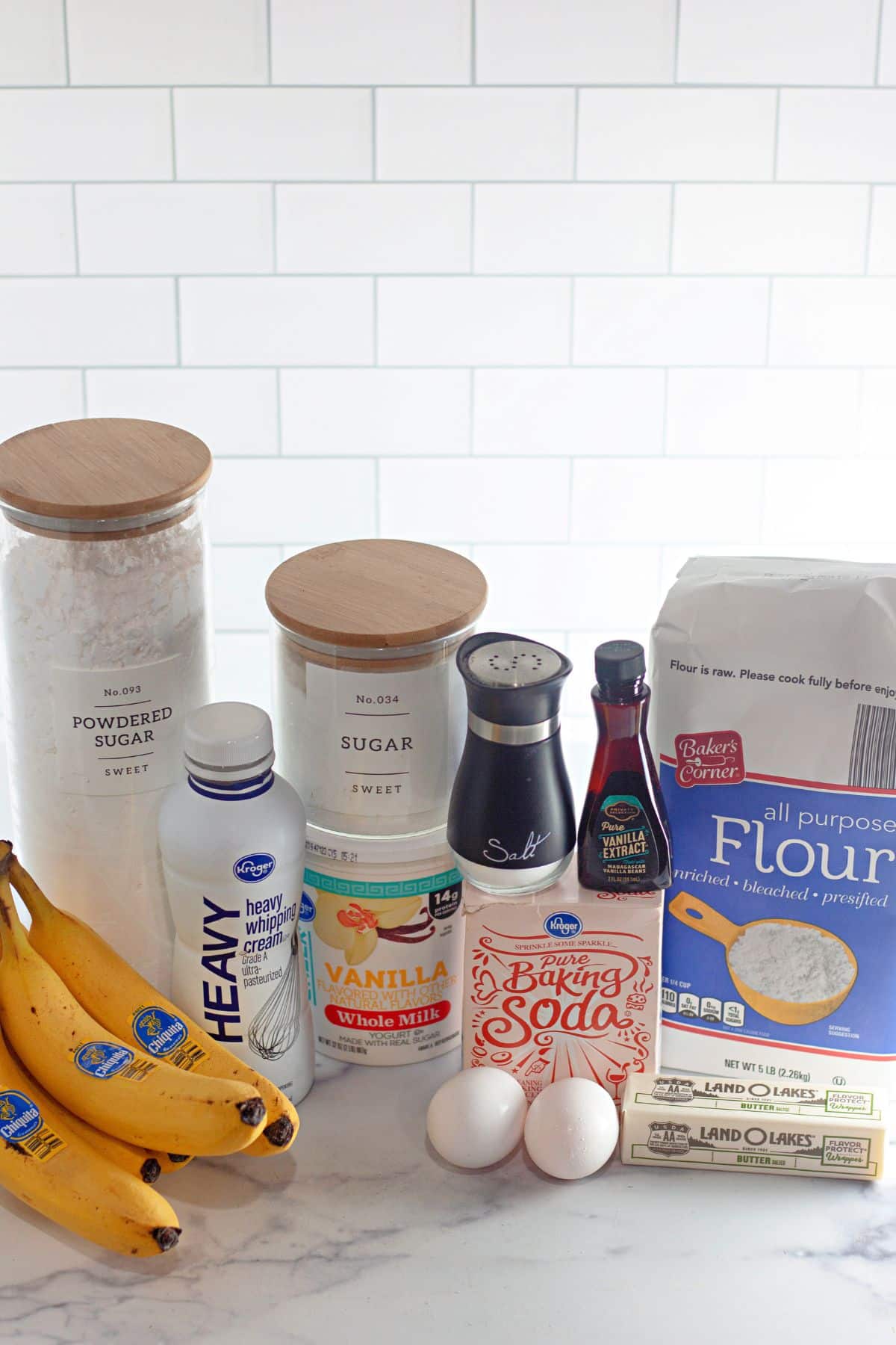 the ingredients needed to make banana cake on a counter.
