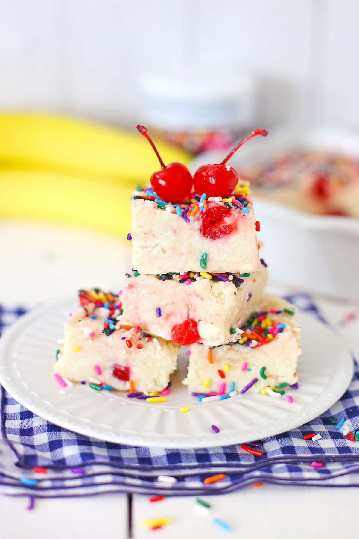 four pieces of banana split fudge on a plate.