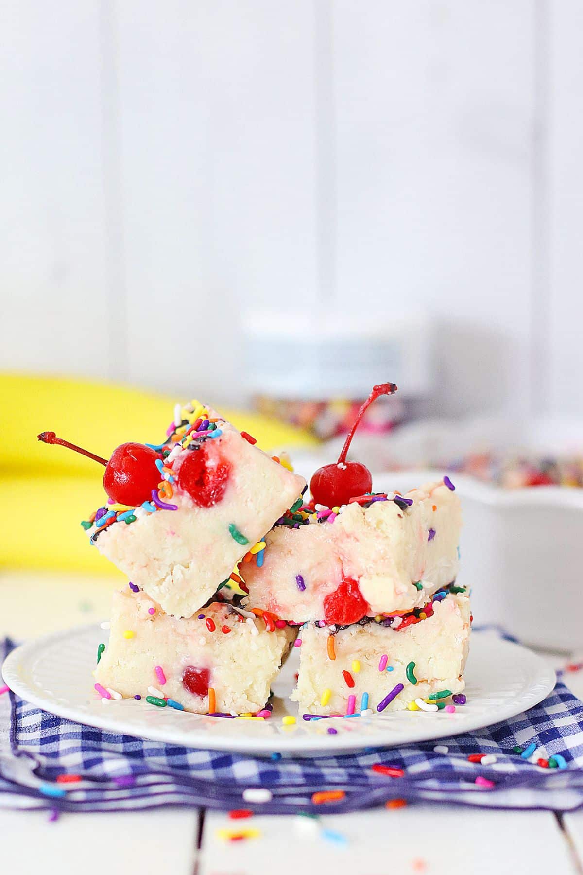 four pieces of banana split fudge on a plate.