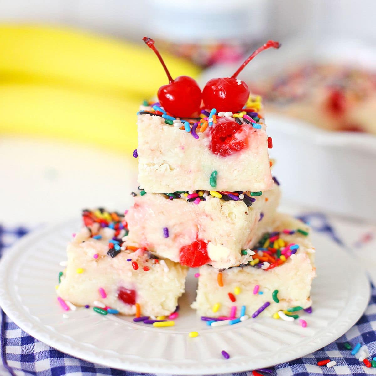 four pieces of banana split fudge on a plate.
