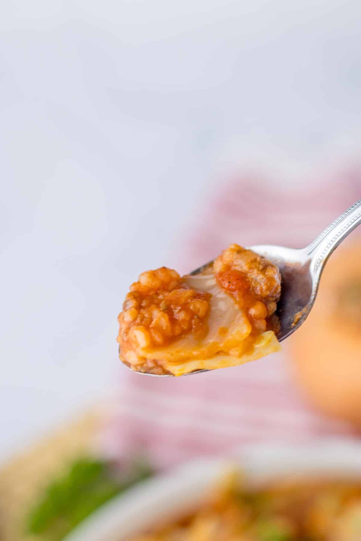spoonful of cabbage roll soup held in the air.