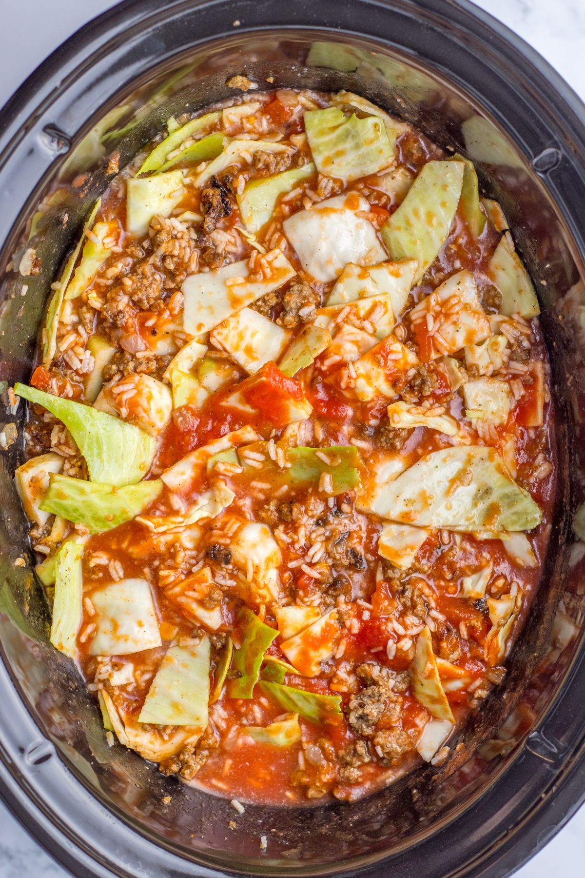 cabbage roll soup in the slow cooker ready to be cooked.