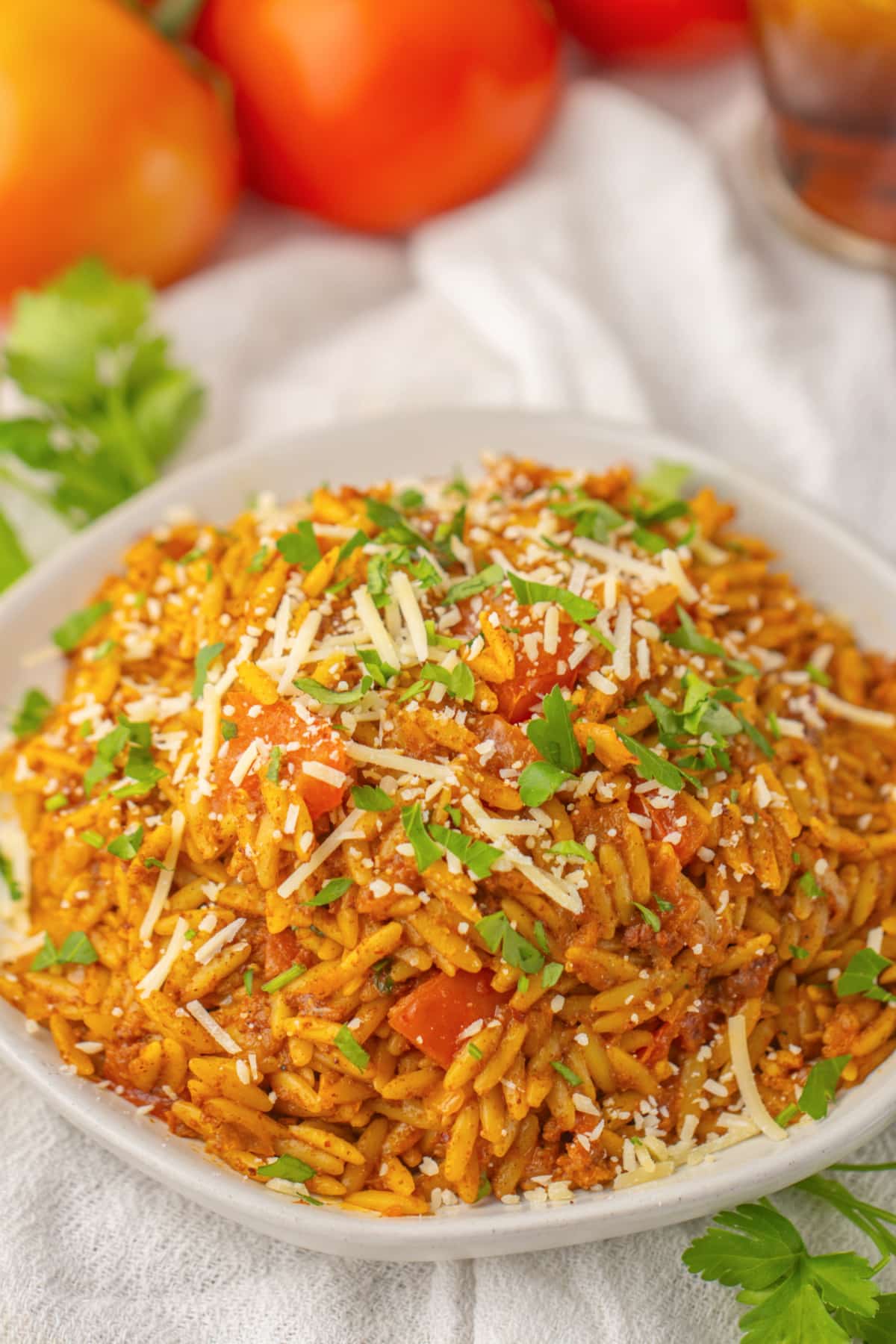serving bowl full of cheesy tomato chorizo orzo.