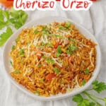serving bowl full of cheesy tomato chorizo orzo.