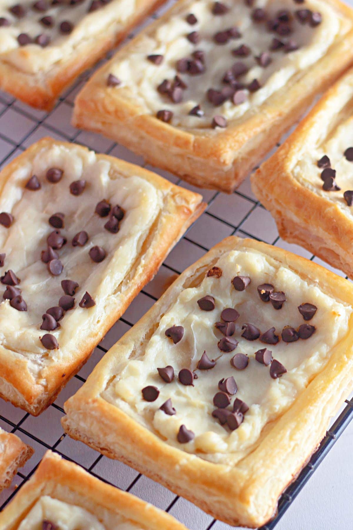 baked chocolate chip danishes on a cooling rack.