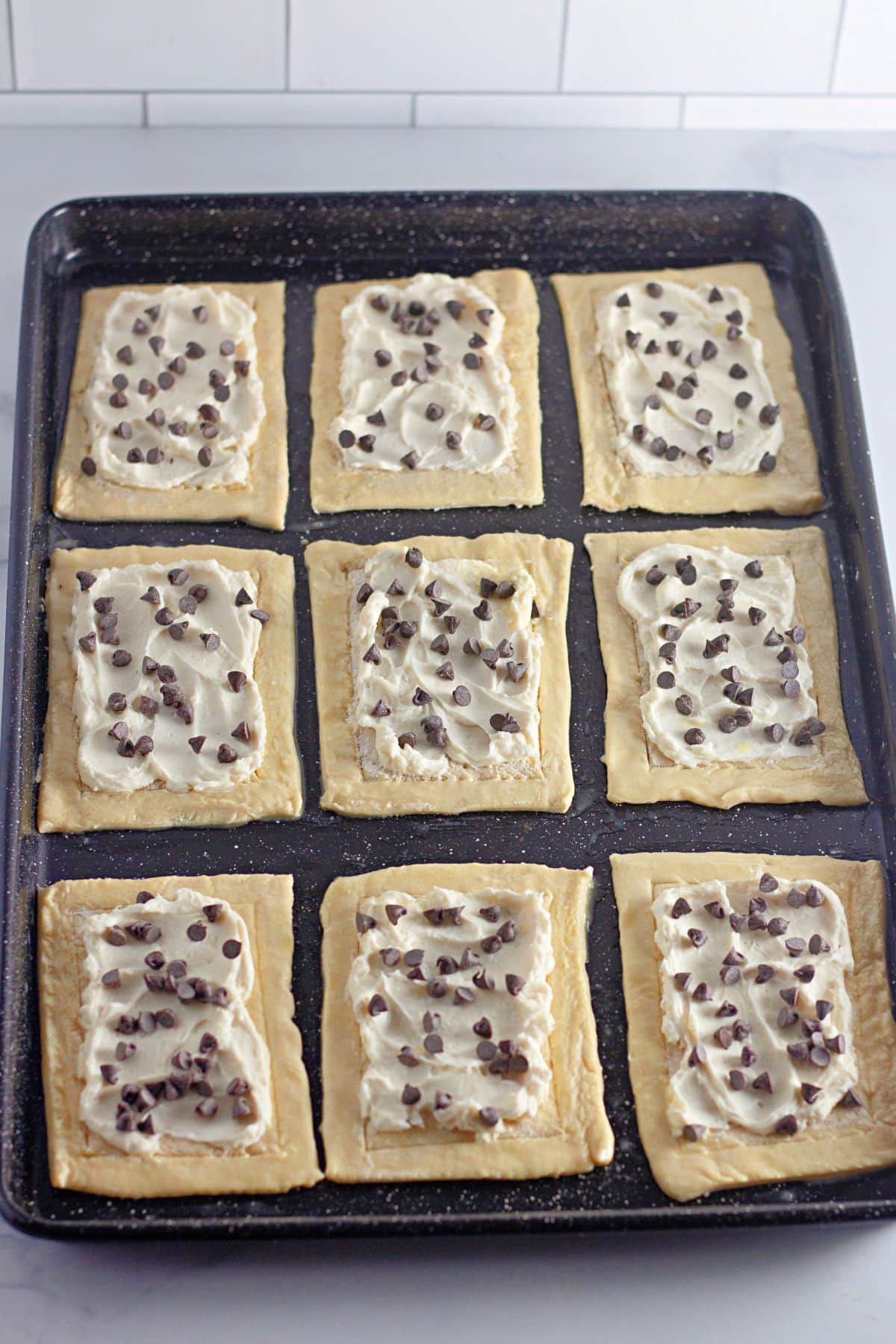 chocolate chips being on top of pastry dough and cream cheese.